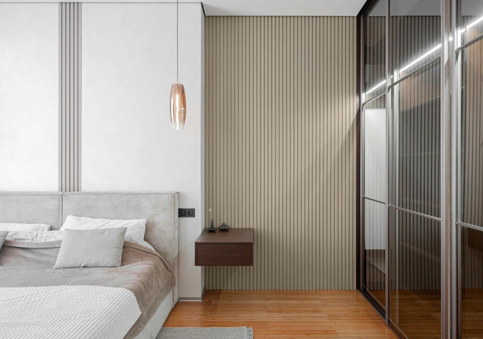 A calm, minimalist bedroom with warm wood tones